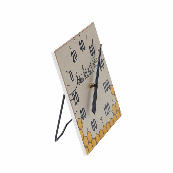 Close up of Bee Kind thermometer with angled stand and metal frame on a white background