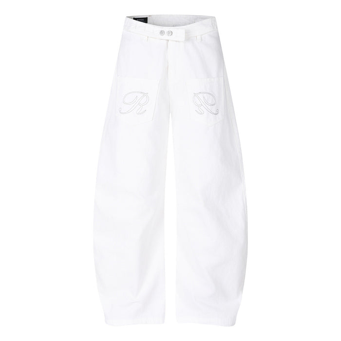White wide-leg jeans shown from the front with embroidered designs on the patch pockets