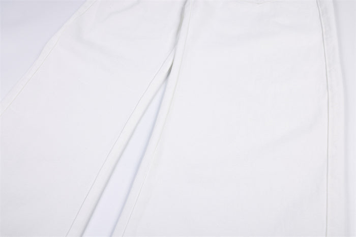 Close-up of the white jeans’ wide leg and vertical seam detailing