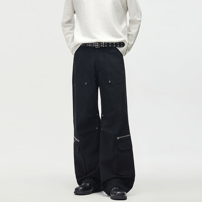 Black men's wide-leg cargo pants with rivet stud hardware, zipper accents, and multiple cargo pockets, front view