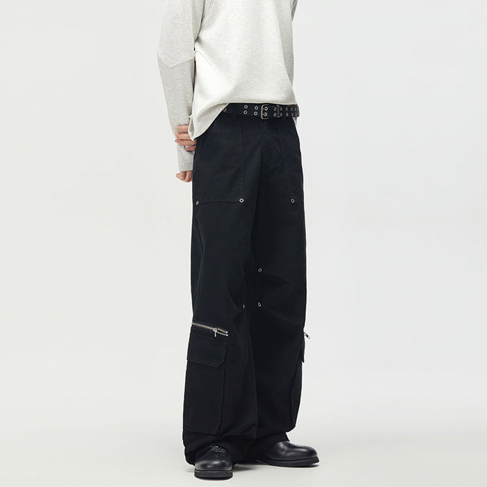 Black cargo pants shown from a rear three-quarter view, highlighting wide legs and side cargo pockets with zippers