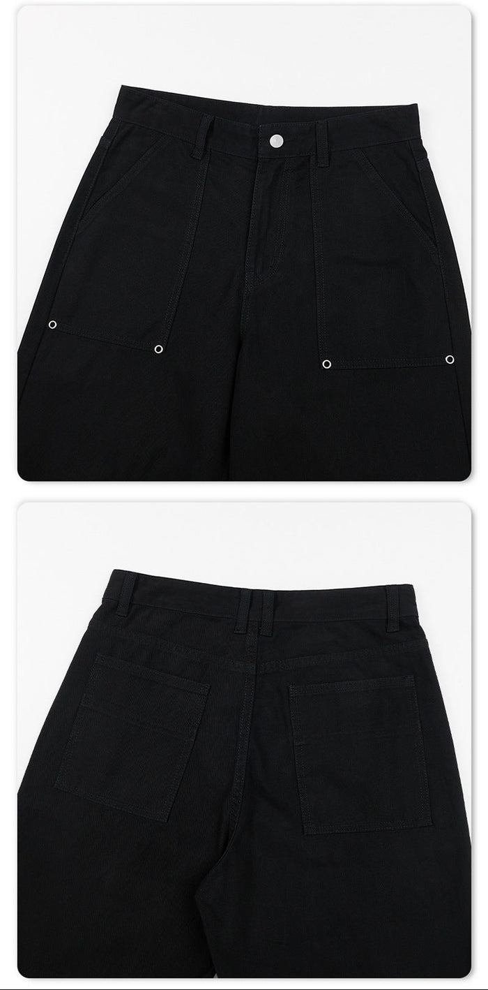 Close-up of black cargo pants showing front and back pocket panels with stitched edges and metal snap fasteners