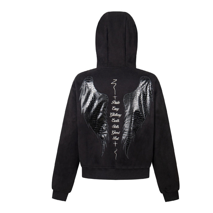 Back view of a black hooded jacket featuring reflective crocodile-texture angel wings and vertical script
