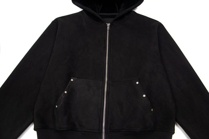 Front view of a black zip-up hoodie with a hood, silver zipper, and snap-detailed front pockets