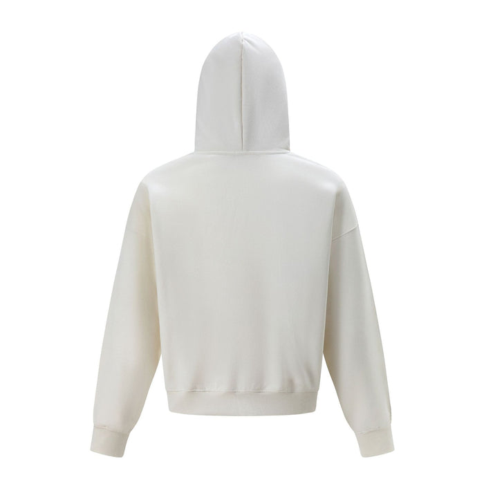 Back view of a cream oversized hoodie showing the plain body, hood, sleeves, cuffs, and ribbed hem