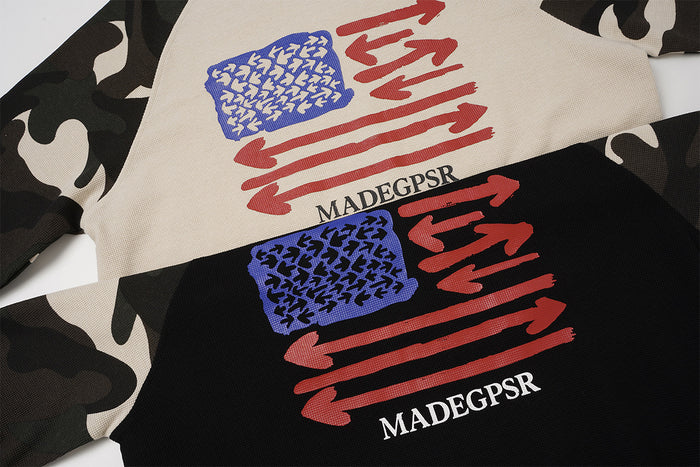 Close-up of black and beige shirt fronts showing blue and red arrow graphics