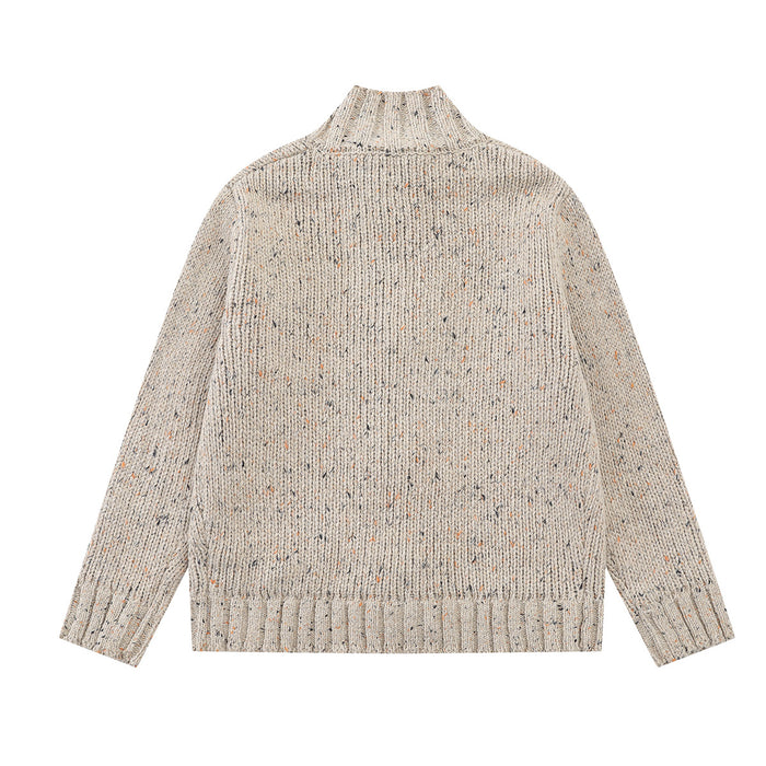 Speckled beige chunky knit cardigan shown from the back with a mock neck and ribbed hem and cuffs