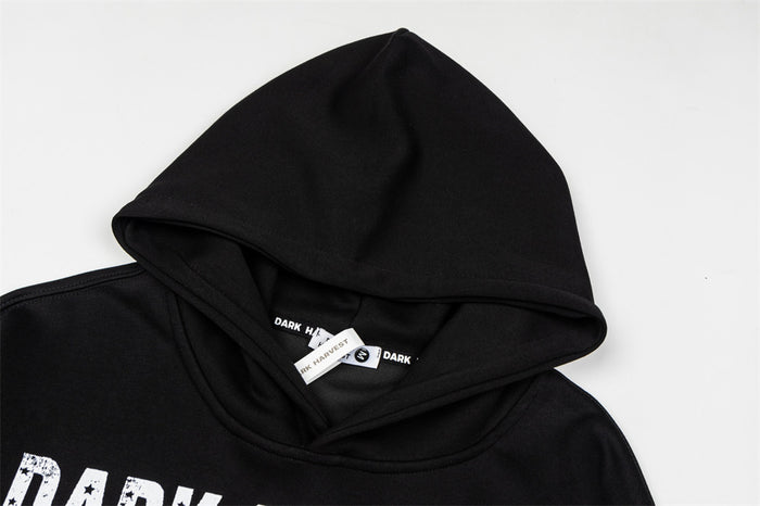 Close-up of the black hood showing the folded edge, inner seam, and neck labels