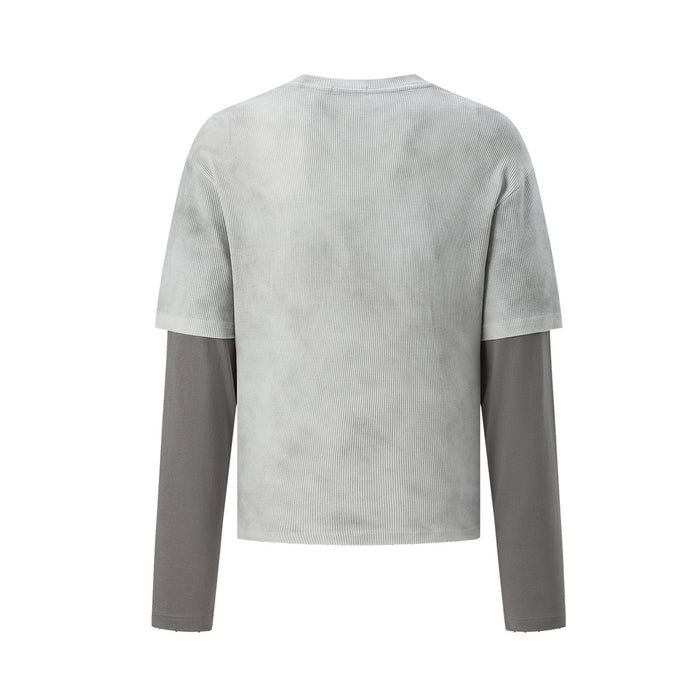Back view of the light gray waffle knit shirt with short sleeves over long gray sleeves