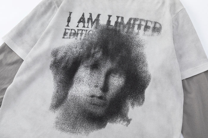 Close-up of the light gray waffle knit front showing a monochrome face graphic and distressed text