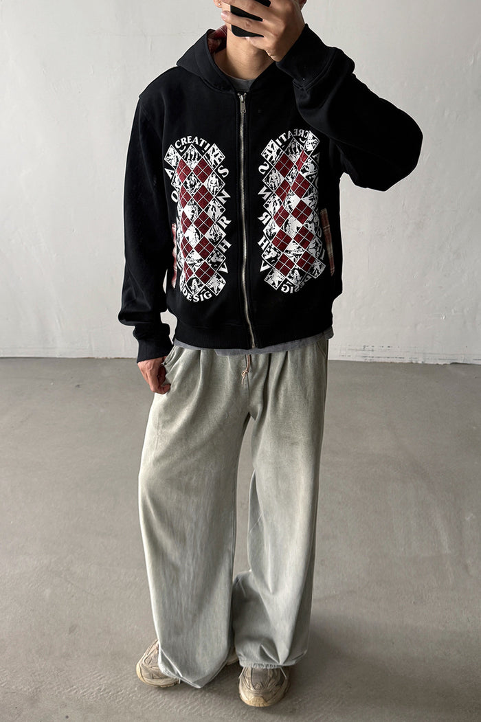 Model wearing a black full-zip hoodie with red, white, and gray argyle graphics on the front