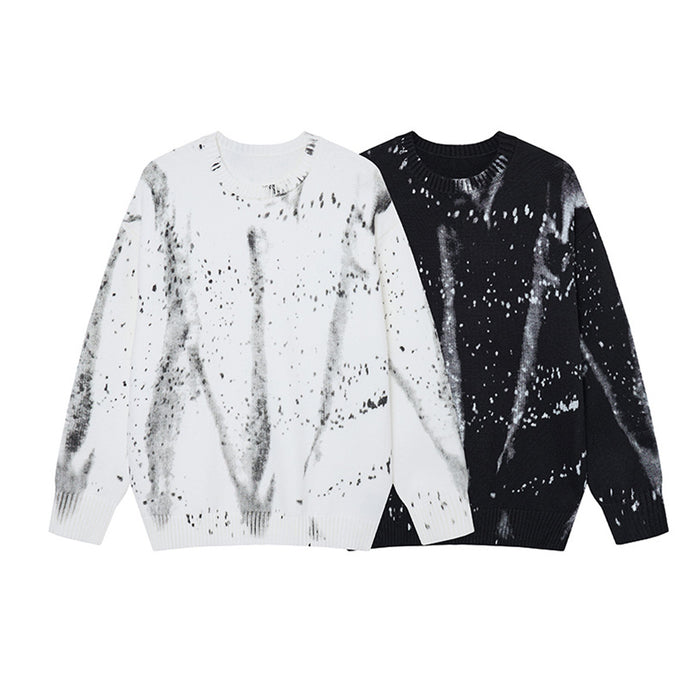 Black and white crew neck knit sweaters with contrasting distressed paint splatter patterns