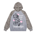 Oversized leopard print raglan hoodie with Dalmatian graphic and pink hearts on black body, front view