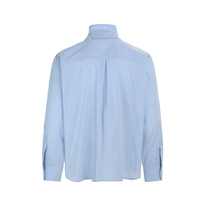 Back view of the light blue long-sleeve shirt with fine vertical stripes, gathered back yoke, and button cuffs