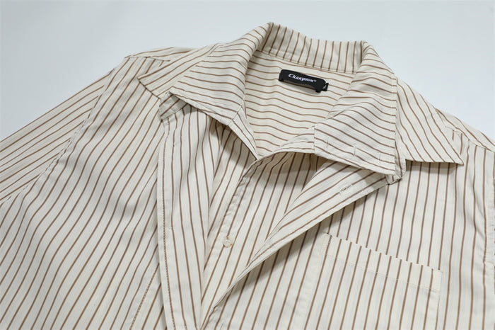 Close-up of the cream striped shirt with its pointed collar opened to reveal the inner placket and chest pocket