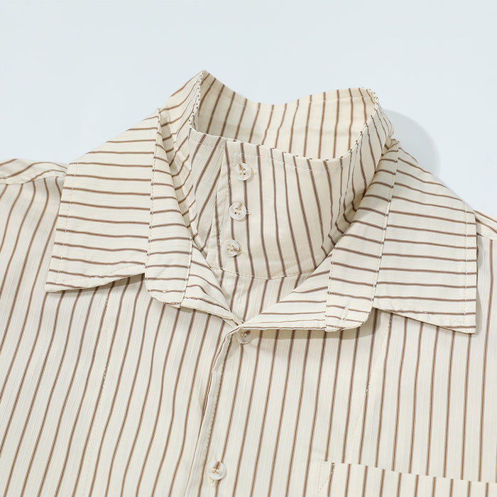 Detail of the cream striped shirt's layered collar, inner stand collar, buttons, and vertical stripe pattern