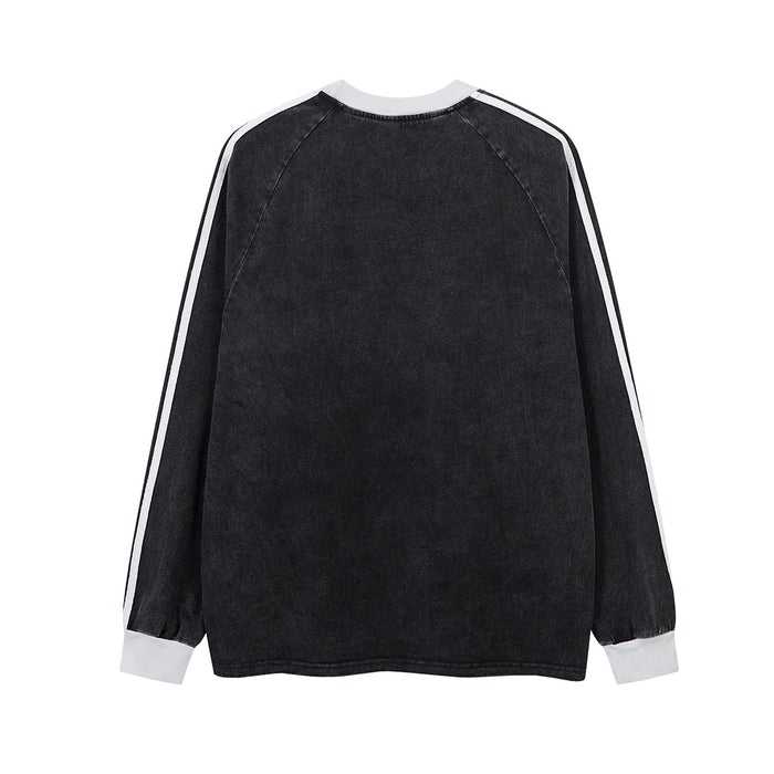 Back view of a black long sleeve raglan shirt with white sleeve stripes and white cuffs