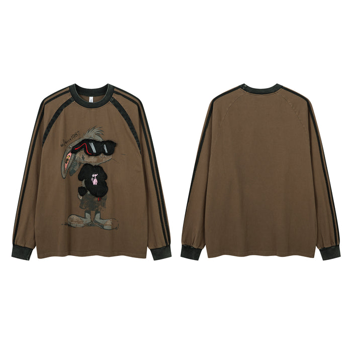 Brown raglan shirt shown front and back with black sleeve stripes, cuffs, and a central graphic