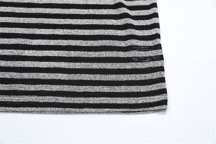 Close-up of the striped shirt hem showing horizontal black and gray fabric and the finished lower edge