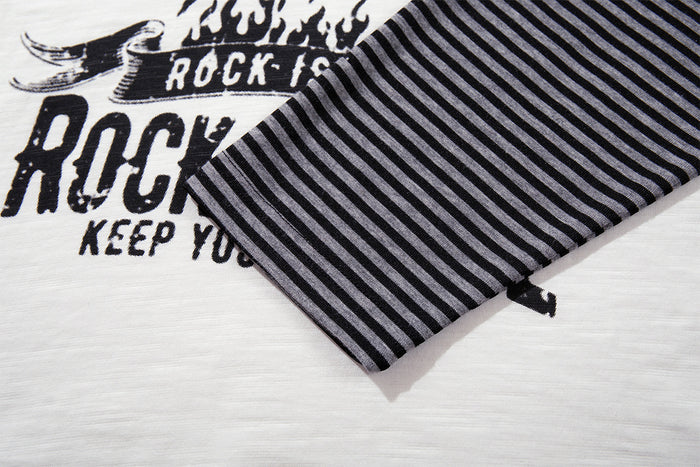Close-up of striped raglan sleeve cuff over the white shirt body and distressed rock graphic