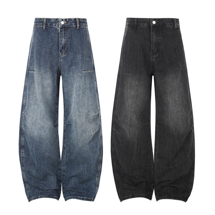 Front view of wide-leg barrel jeans in washed blue and black denim with curved legs and low pocket seams