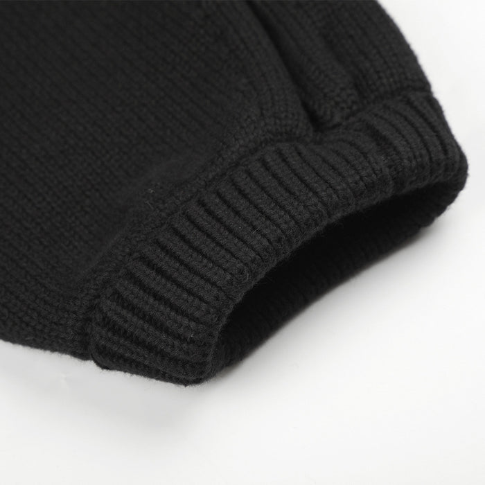 Close-up of the black knit jacket ribbed sleeve cuff with textured knit fabric