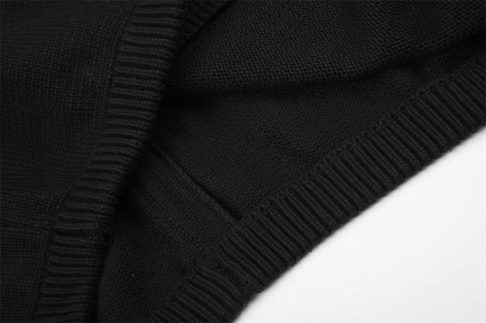 Detail of the black knit jacket ribbed hem and adjoining textured knit panel
