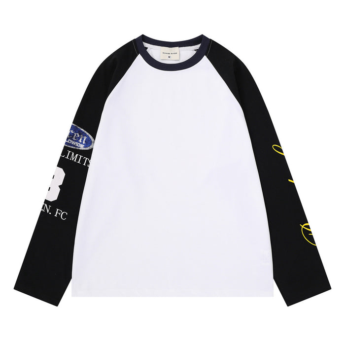 White raglan long sleeve tee with black sleeves, dark collar, and yellow graphic sleeve print
