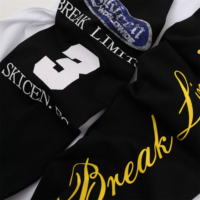 Close-up of black sleeves showing blue, white, and yellow graphic prints with text details