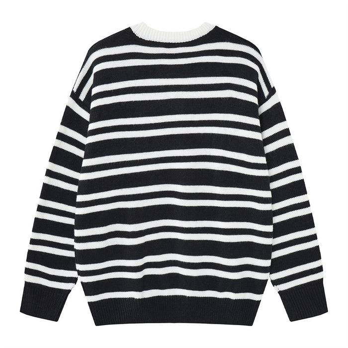 Back view of a black and white striped knit sweater with a plain white crew neckline and ribbed black hem