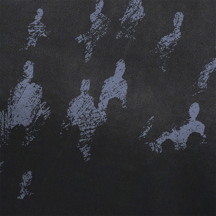 Close-up of the distressed blue-gray seated-figure and star graphic on black fabric