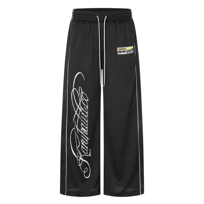 Karukawa men's black mesh wide-leg pants with cursive script logo print and white side piping