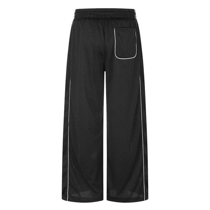 Back view of black wide-leg mesh pants showing an outlined pocket, white piping and straight wide legs