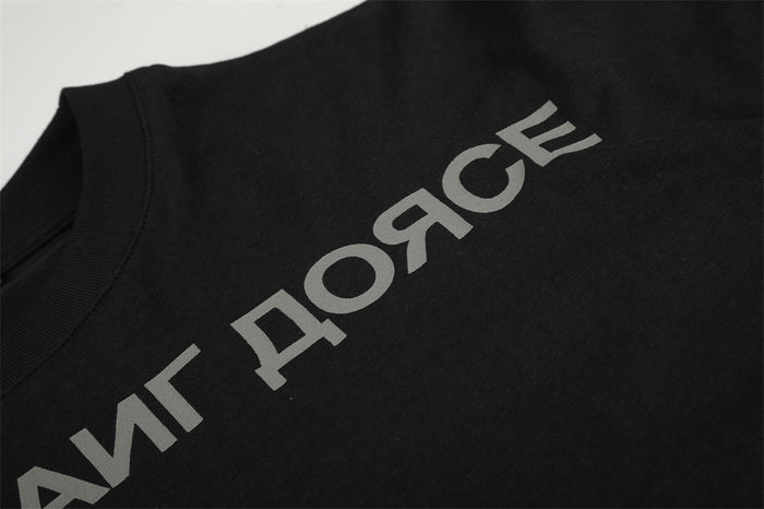 Detail of gray Cyrillic lettering across the chest area of the black long-sleeve T-shirt