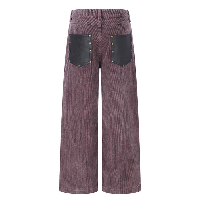 Back view of mauve corduroy pants with two black leather-look patch pockets and brass-tone studs