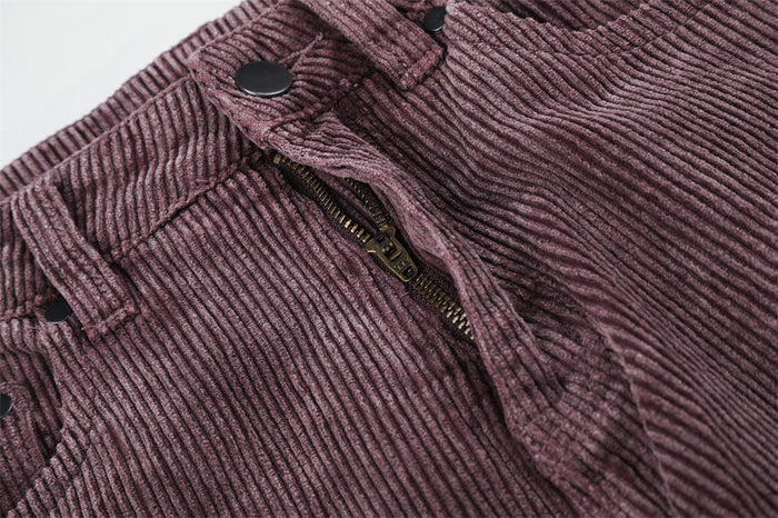 Close-up of the mauve corduroy waistband and partially opened fly with a metal zipper