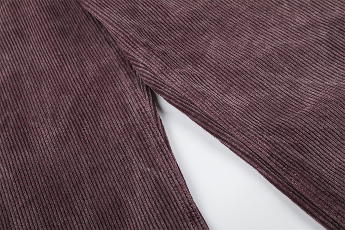 Close-up of mauve corduroy fabric along the wide leg and inner seam, highlighting the ribbed texture