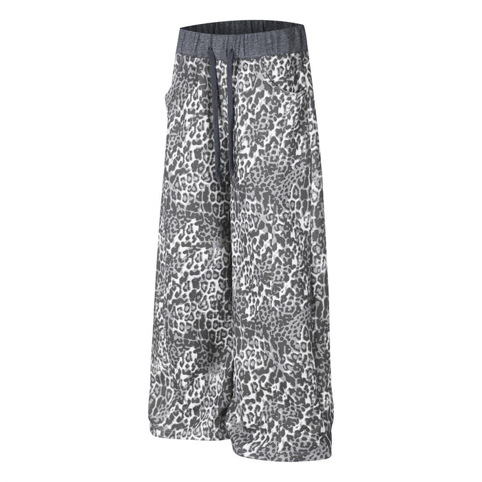 Angled front view of grey leopard-print wide-leg sweatpants with draped legs