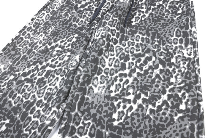 Close-up of the grey leopard-print sweatpants fabric and wide-leg panel seam