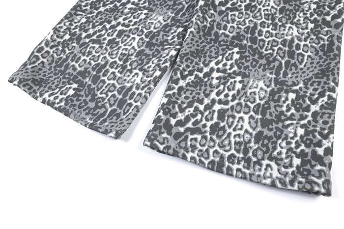 Close-up of the wide-leg sweatpants hems showing the separated leg openings