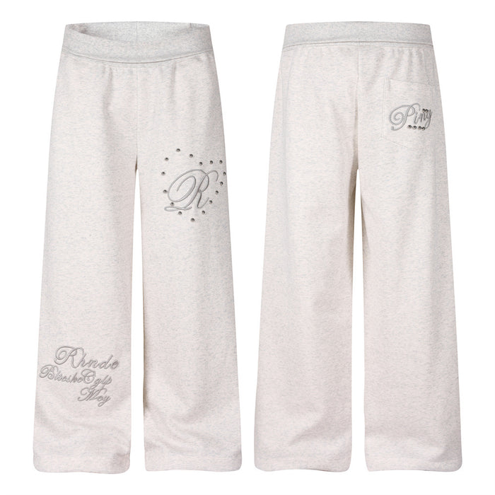 Men's heather grey wide-leg sweatpants with 3D script R embroidery and silver dome studs on left thigh, front and back view
