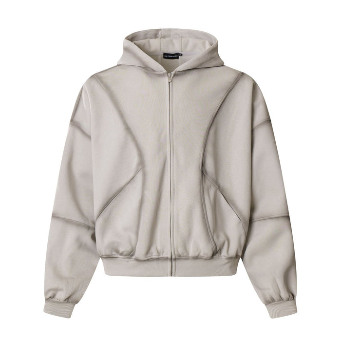 Oversized men's full-zip hoodie in washed grey with diagonal panel seams and ribbed cuffs, front view