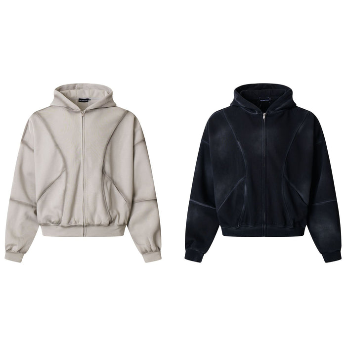 Front view of oversized full-zip hoodies in light beige and black with panelled seams and ribbed cuffs