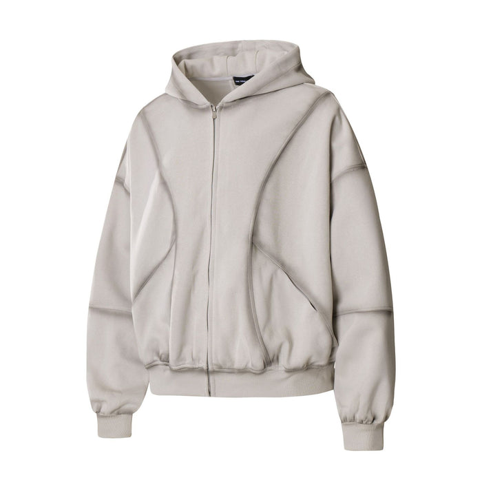Front view of a light beige oversized zip-up hoodie with hood, full zipper, curved panels and ribbed cuffs