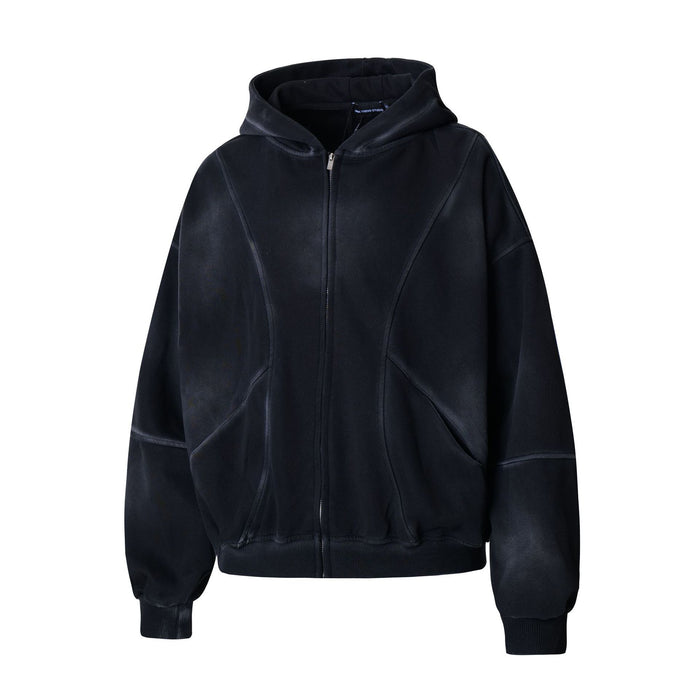 Angled front view of the black oversized hoodie with full zipper, hood, curved pockets and ribbed cuffs