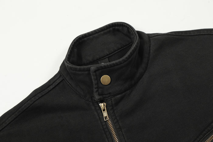 Close-up of the black jacket collar showing a gold snap button and front zipper