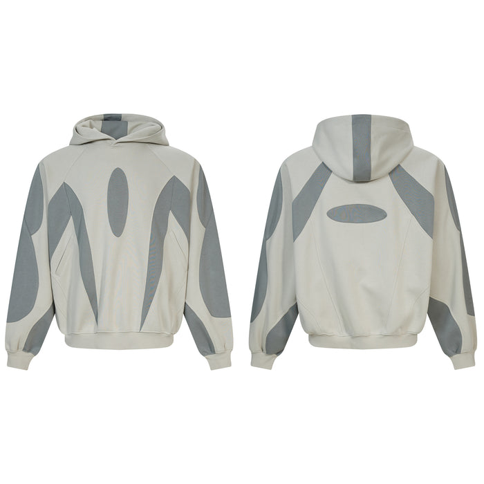 Oversized grey and cream two-tone patchwork pullover hoodie with oval appliqué, front and back view