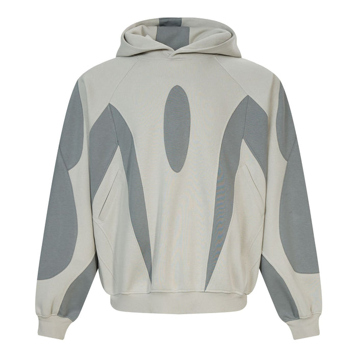 Front view of a light gray hoodie with dark gray abstract patchwork panels, hood, cuffs, and front pocket