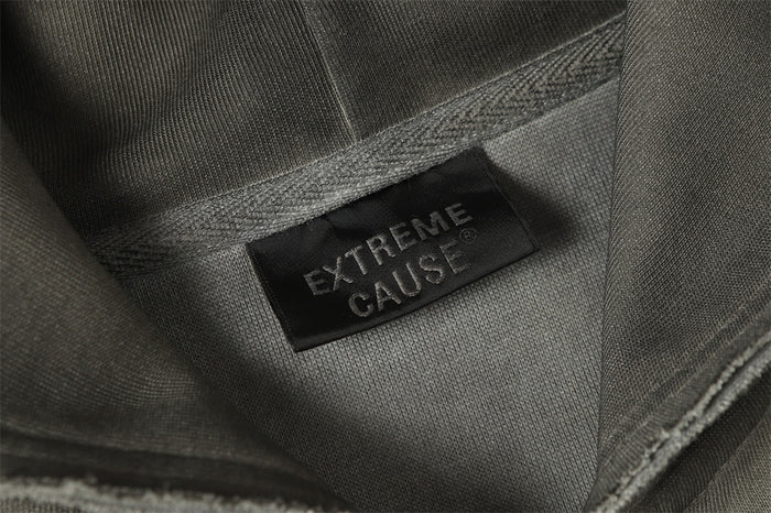 Close-up of the hoodie interior showing a black sewn label against the washed gray fabric