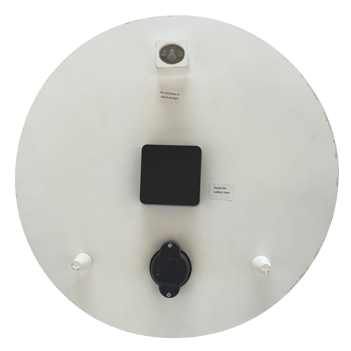 Back view of Pumpkin Time Poly Resin Clock showing AA battery compartment and a do not place in direct sunlight warning